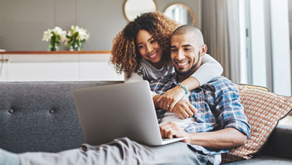 Couple reading laptop