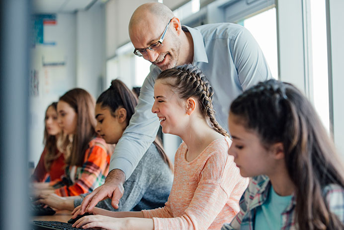 Teacher helping students