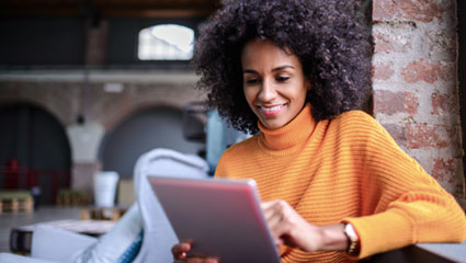 Woman using iPad to view FAQ's