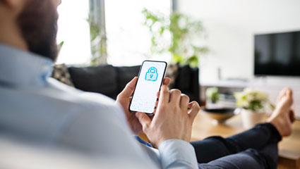 Person holding Smartphone with lock icon on screen