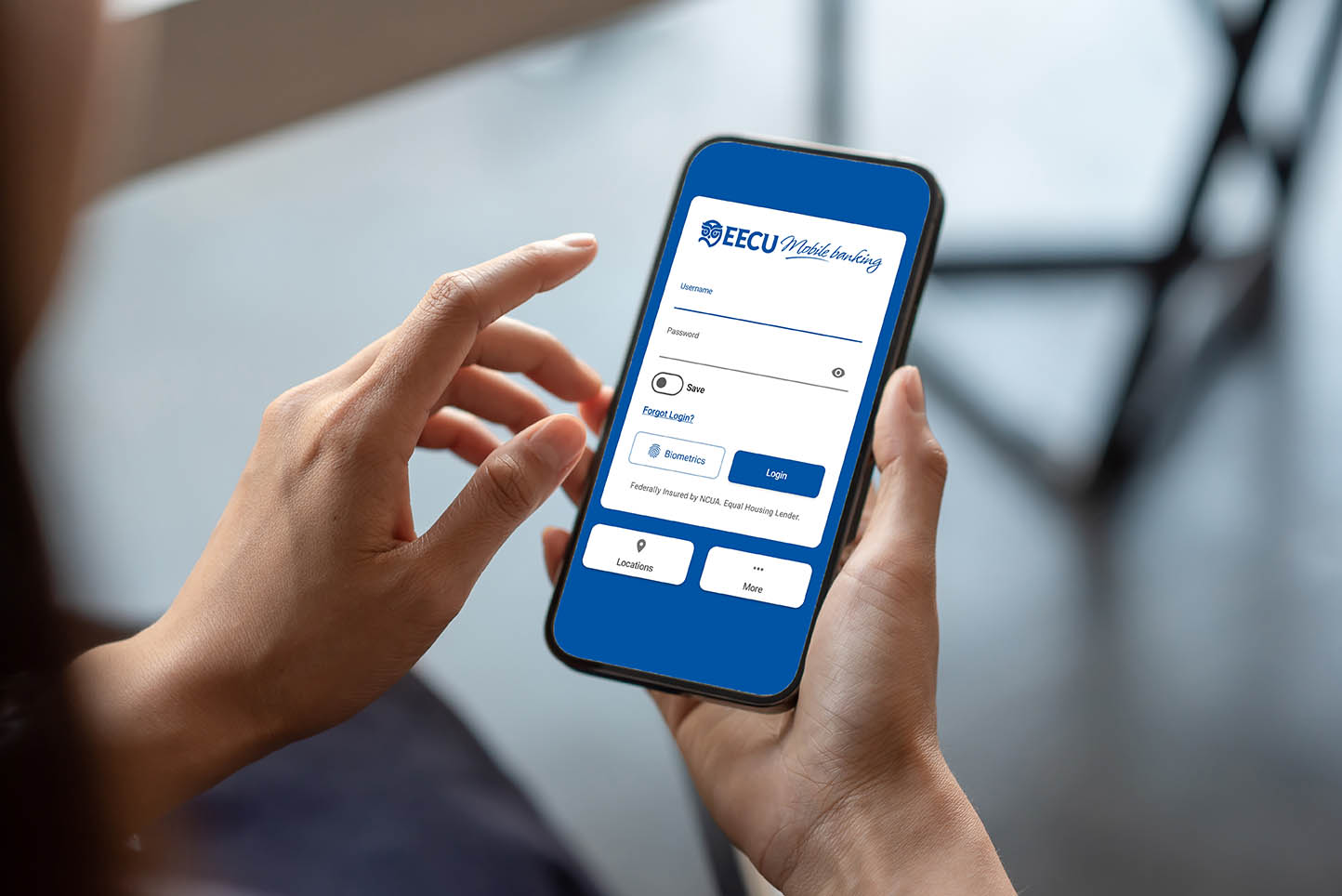 hands holding a phone with the mobile applications login screen pulled up