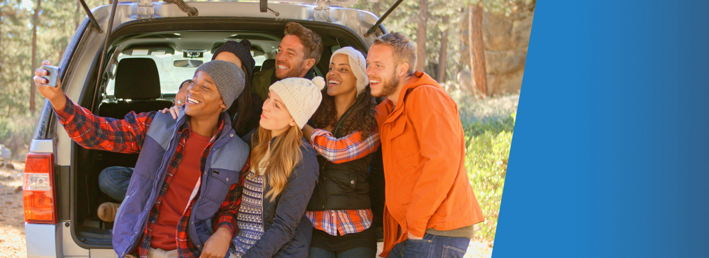 6 People taking a selfie in the back of a car wearing cold weather apparel