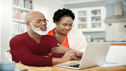 Man and woman using laptop to view privacy notices