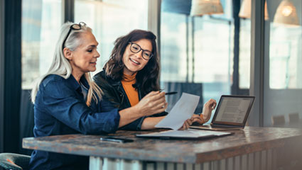 Two women reviewing document