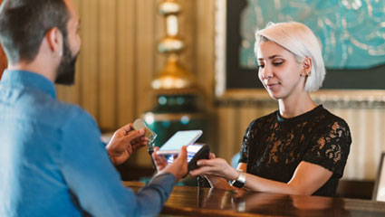 Man paying at register using Samsung Pay