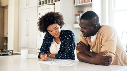 Couple looking at document on table