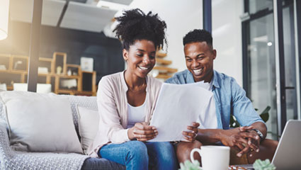 Couple sitting looking over papers