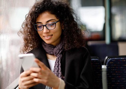 Young mixed ethnicity female banking on her mobile phone
